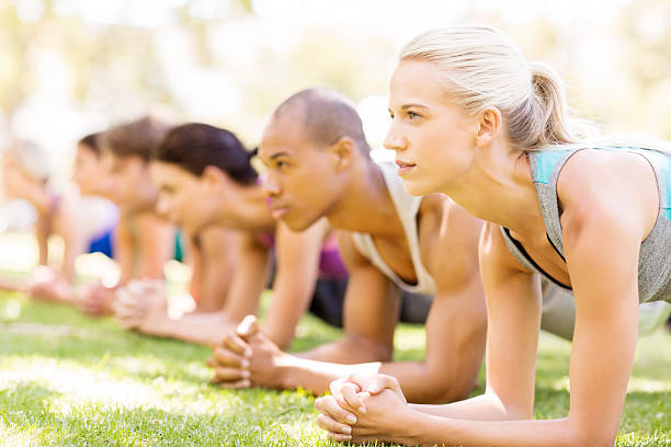 istock Woman With Friends In Plank Position In Bootcamp 507065345