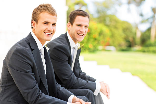 istock Best Man And Groom Looking Away While Sitting Together 507065627