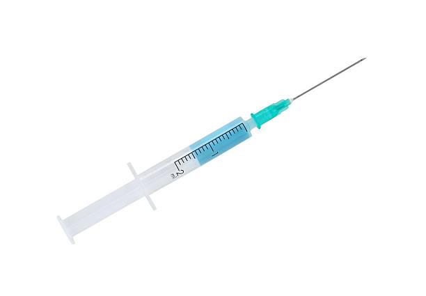 istock Medical syringe with blue liquid 507066483