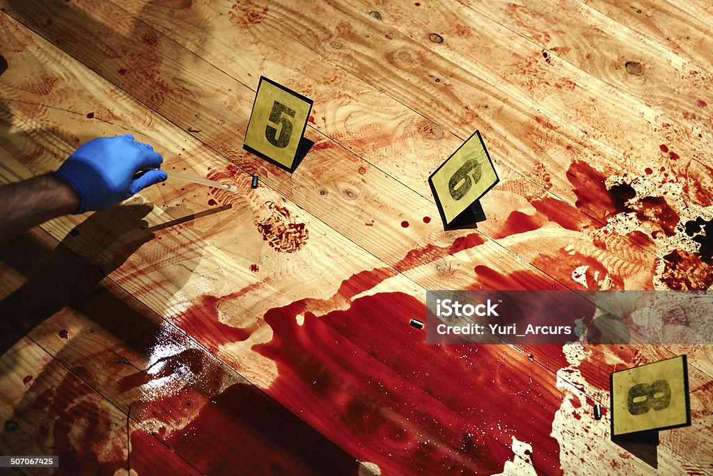 Collecting bloody evidence Cropped shot of a bloody crime scene floor with a hand collecting evidence Crime Scene Stock Photo