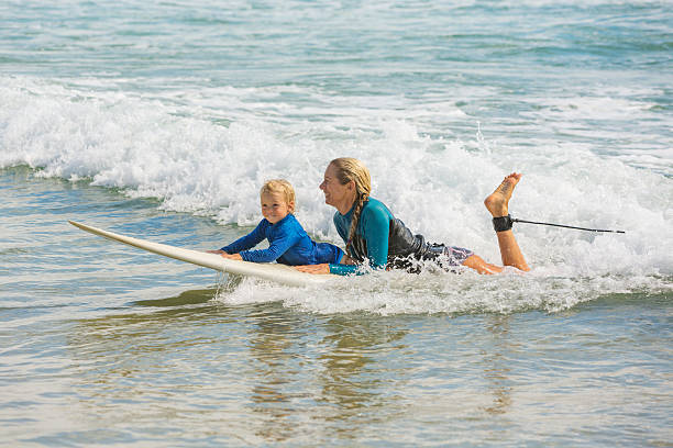 istock Mother Taking Her Young Child Surfing at the Beach 507068122