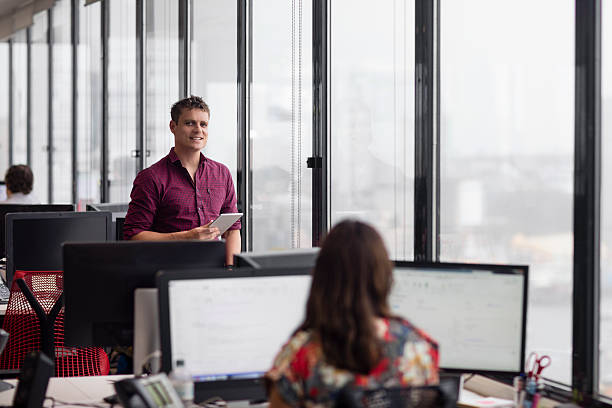 Portrait of a businessman in the office Portrait of a businessman standing next to the window at the office. stars in your eyes stock pictures, royalty-free photos & images