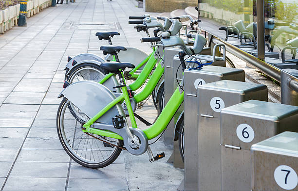 istock Bicycles for rent in city on background. 507069932