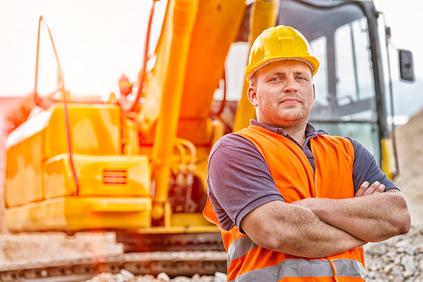 Earth Digger Driver Earth Digger Driver at construction site bulldozer photos stock pictures, royalty-free photos & images