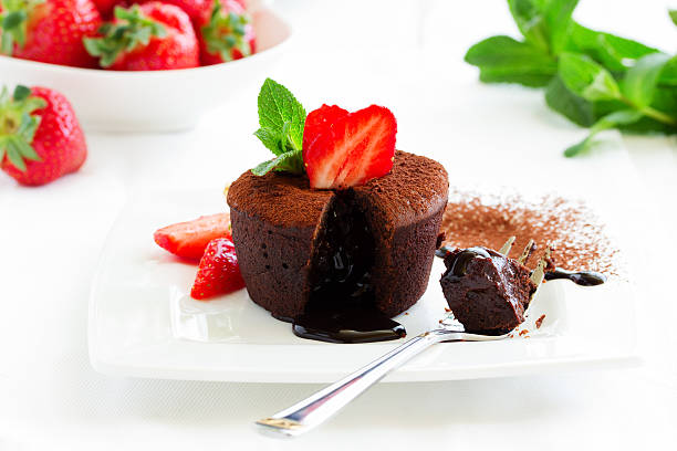 istock chocolate pudding with fudge center with strawberries, 507072750