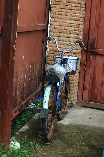 istock Old Bicycle Parked In Front Of The Orange Bricks Pole 507073080