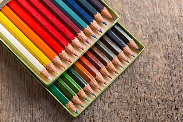 Colored pencil in box on old wooden table