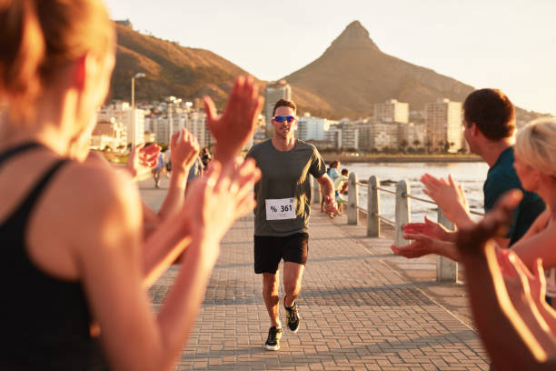 istock Young people encouraging runners at finish line 507075562
