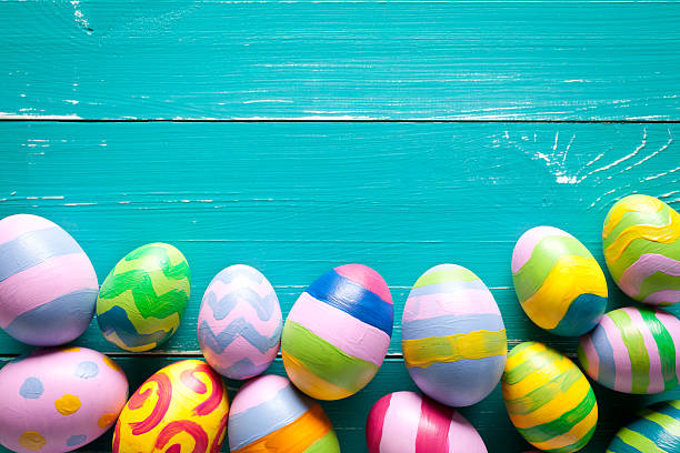 istock Colorful easter eggs on turquoise wooden table 507076432