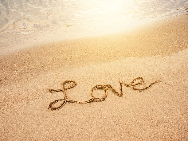 istock Love lettering message written on Sand Beach background 507076602