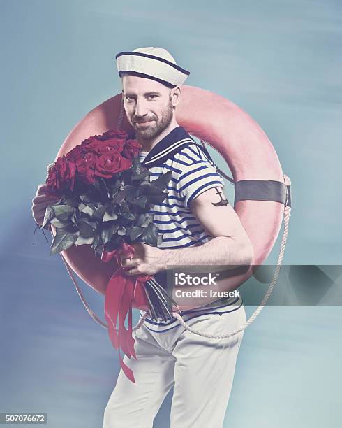 Bearded Sailor Holding Lifebuoy And Bunch Of Roses Stock Photo - Download Image Now - Sailor, Tattoo, Valentine's Day - Holiday