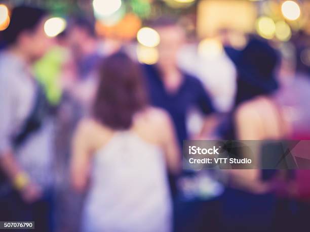 Hipster Party Men And Women In Festival Event Blurred Background Stock Photo - Download Image Now