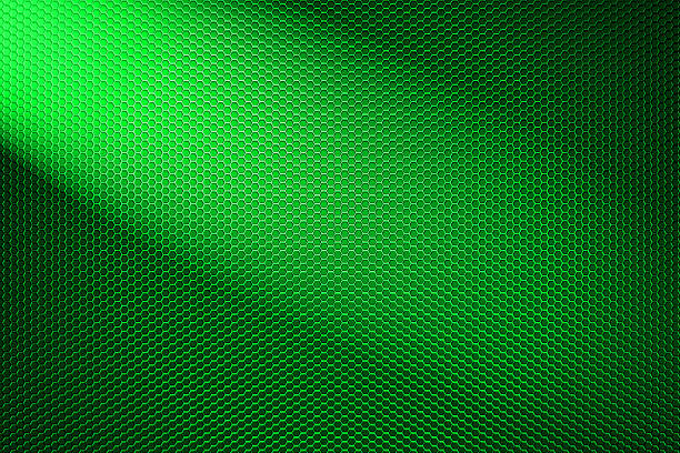 istock spotlight on green metallic mesh background. 507079016