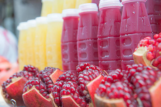 Close Up with a blurry fresh pomegranate juice in a bottle