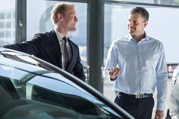 istock Car dealer showing vehicle 507082754