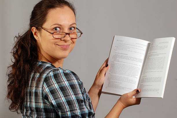 istock smiling woman in glasses with a book 507089729