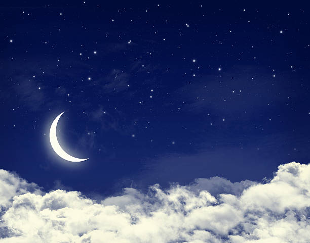 istock Moon and stars in a cloudy night blue sky 507093129