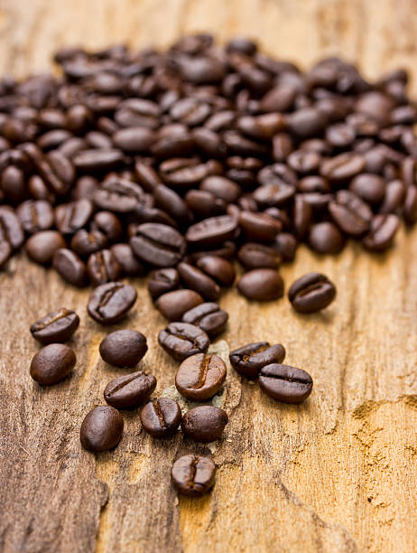 istock Coffee beans on wood background 507093571