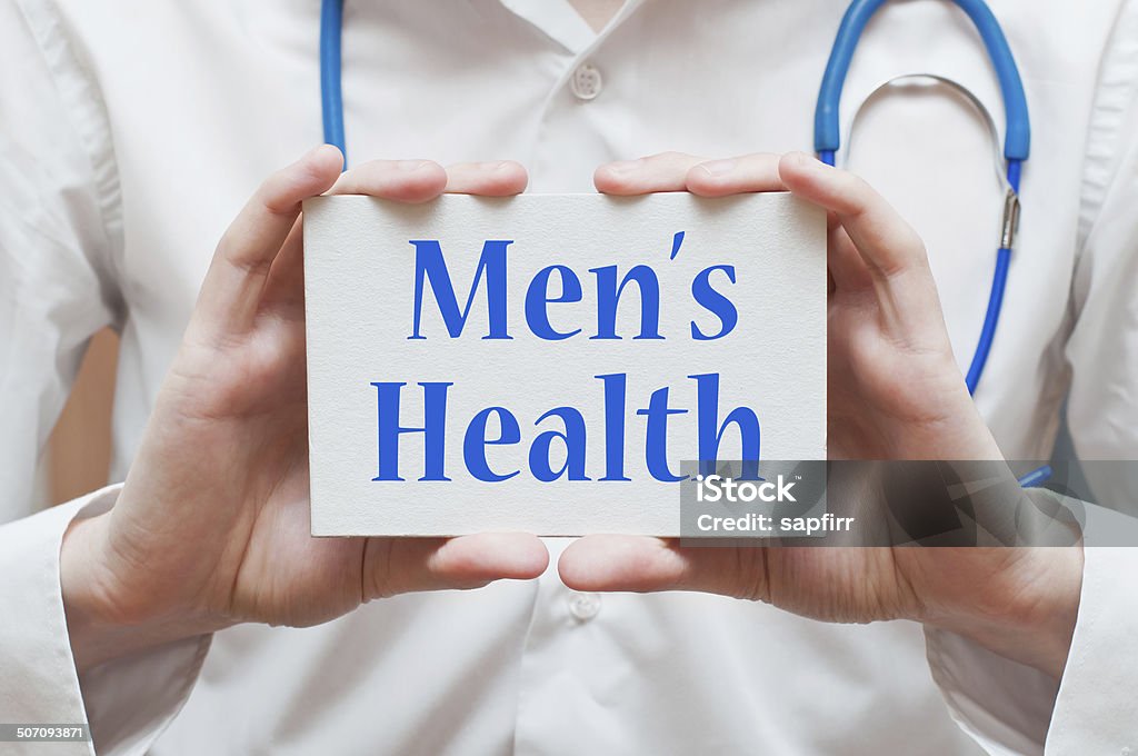 Men's Health concept Men's Health concept written on a signboard in doctor's hands Accidents and Disasters Stock Photo