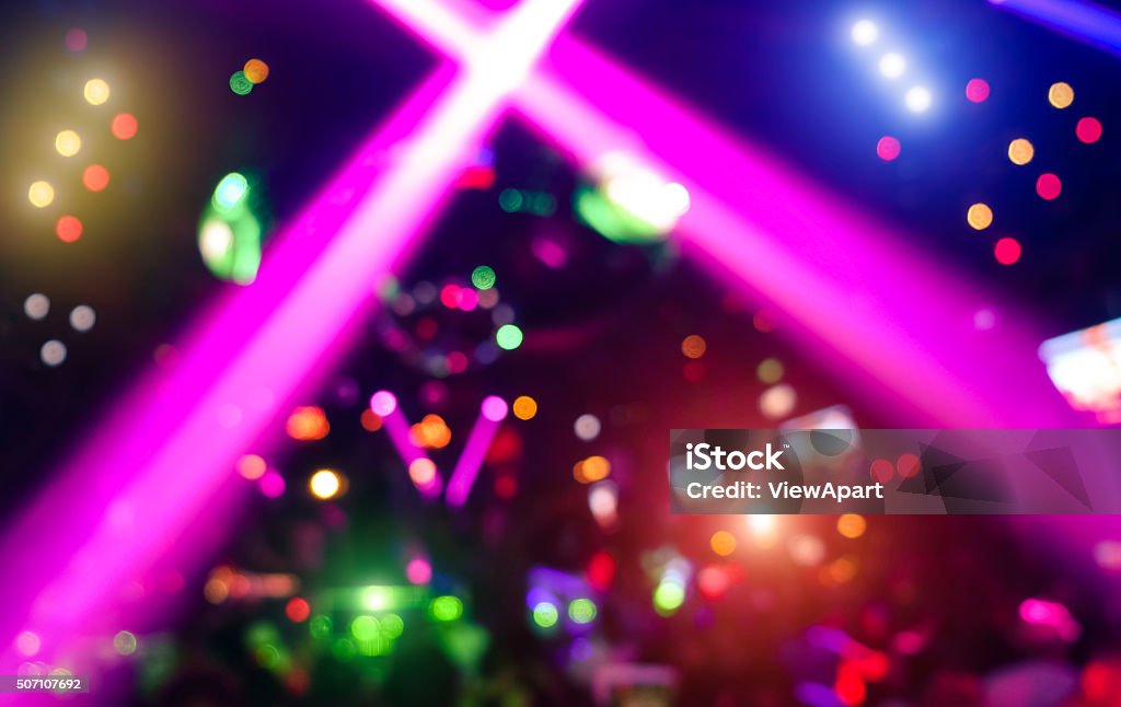 Abstract background with defocused bokeh laser show in modern nightclub Abstract background with defocused bokeh of laser show in modern disco party night club - Concept of nightlife with music and entertainment - Image with powered colored halos and vivid bright lights Nightclub Stock Photo