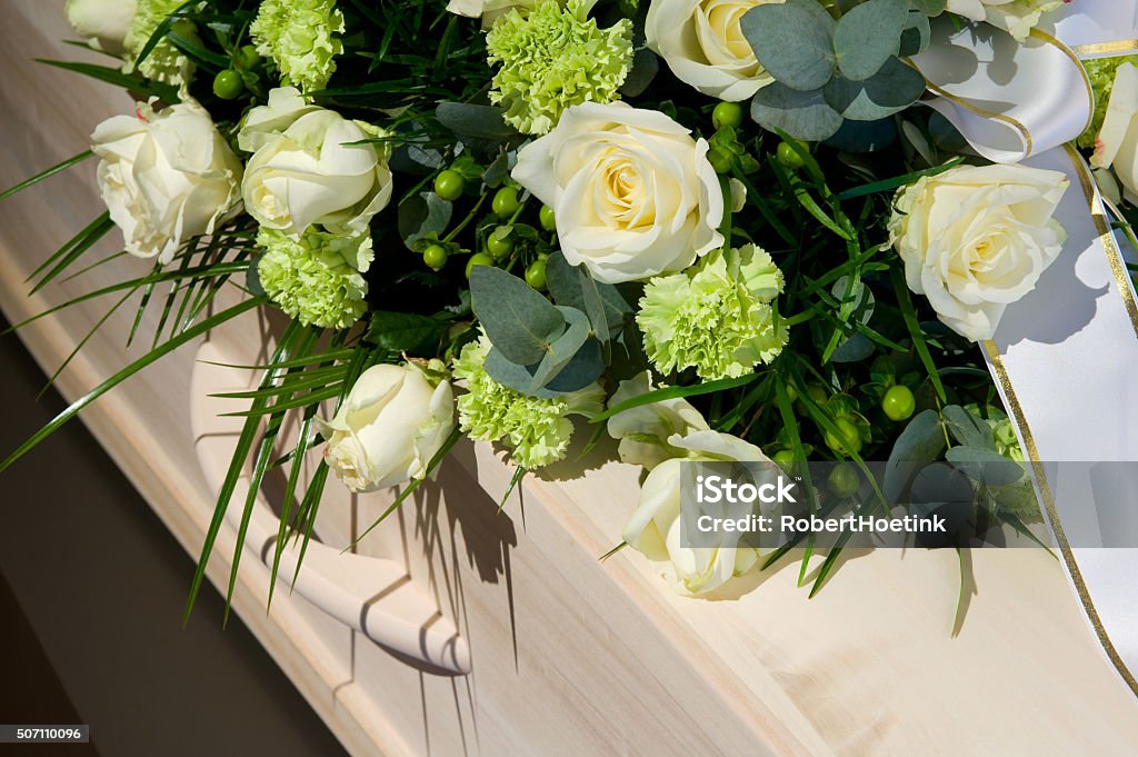 Coffin in morque A coffin with a flower arrangement in a morgue Funeral Stock Photo