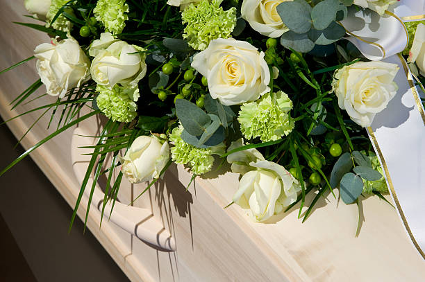 Coffin in morque A coffin with a flower arrangement in a morgue coffin photos stock pictures, royalty-free photos & images