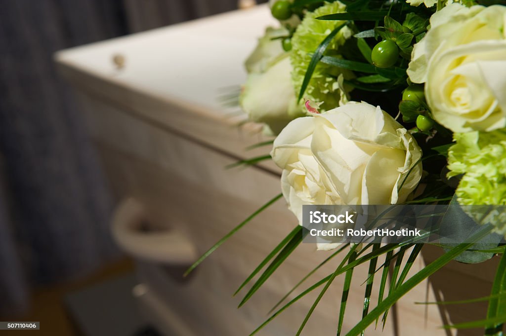 Coffin in morque A coffin with a flower arrangement in a morgue Undertaker Stock Photo