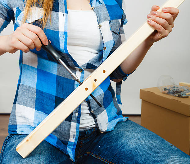 istock Human hands assembling wooden furniture. DIY. 507110736