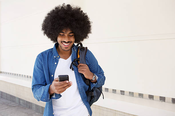 istock Cool guy walking with mobile phone and bag 507110982