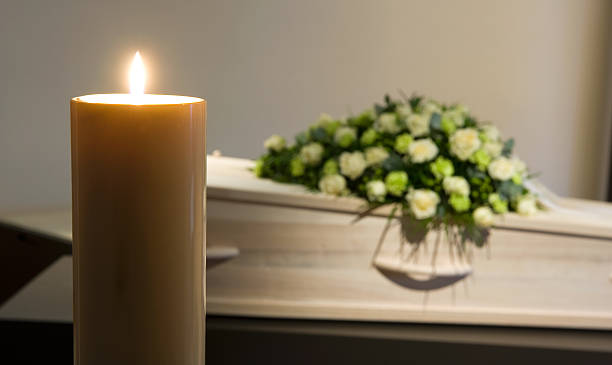 istock Burning candle in front of coffin 507111118