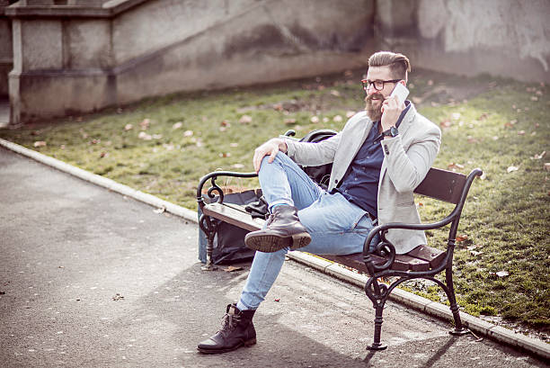 istock smiling stylish man talking on the phone 507111190