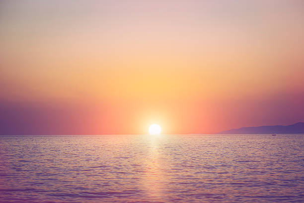 Sunset Sunset over sea horizon over water stock pictures, royalty-free photos & images