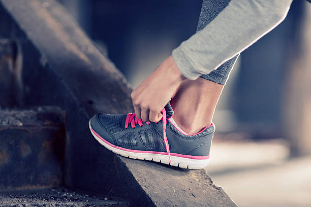 istock Woman tying her exercise shoes 507112532