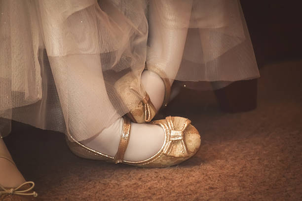 Pigeon toed bridesmaid's feet Cute, young bridesmaid, with her feet crossed. flower girl stock pictures, royalty-free photos & images