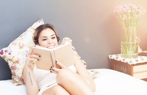 istock Young beautiful woman reading a book in bed 507113226