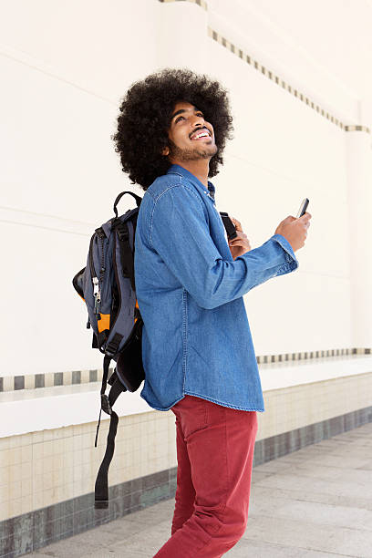 istock Happy man walking with bag and mobile phone 507113270