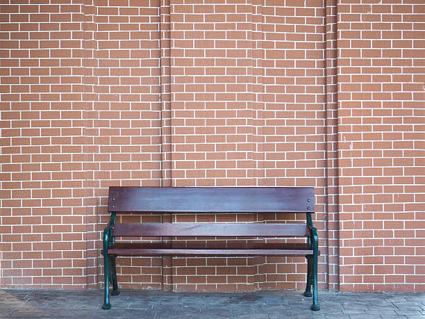 istock wooden bench and brick wall 507113302