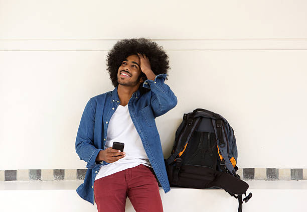 istock Cool travel guy relaxing with mobile phone 507113812