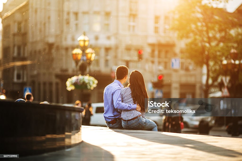 Couple have fun in the city man and woman posing and have fun in the old town Adult Stock Photo
