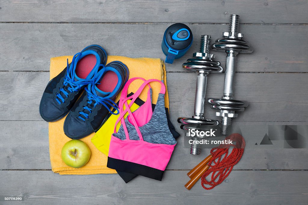 colorful fitness equipment on wooden floor top view of colorful fitness equipment on wooden floor Active Lifestyle Stock Photo