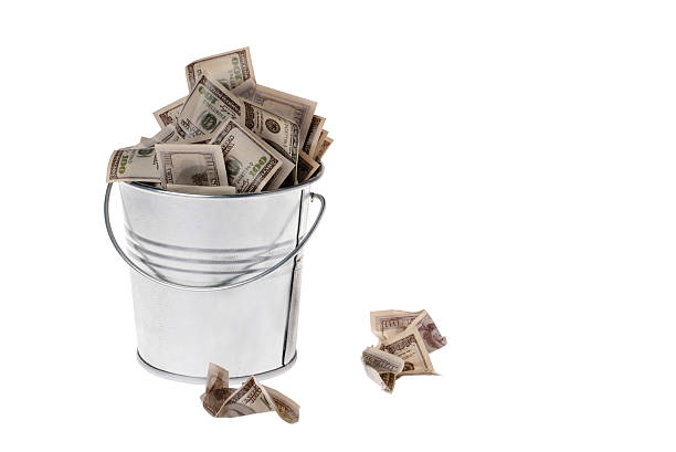 istock dollars in a metal bucket 507115732