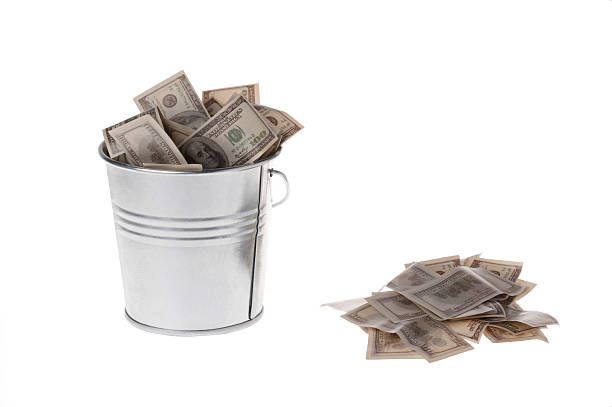 istock dollars in a metal bucket 507115802