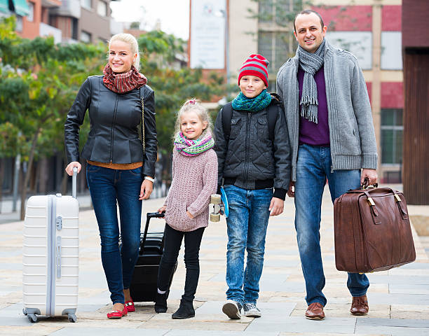 istock Parents with two kids  chasing streets 507118240