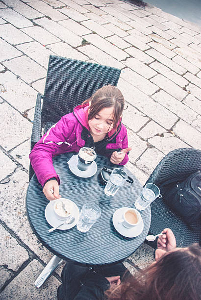 Mother and Young Daughter in a Bar Outdoors