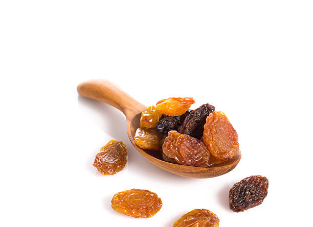 istock jumbo raisins in wooden spoon on white 507119378