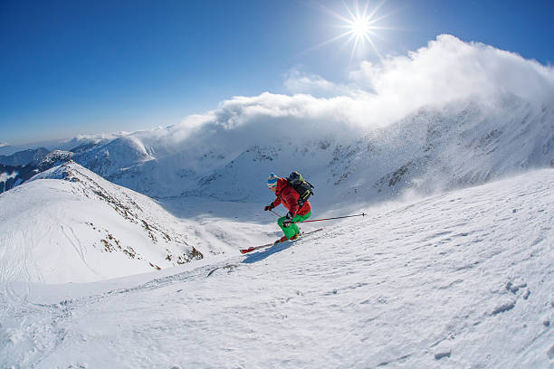 istock Skier skiing downhill in high mountains against sunset 507120387