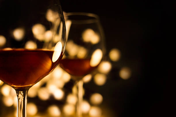 Red wine in two glasses with beautiful lights,black background stock photo