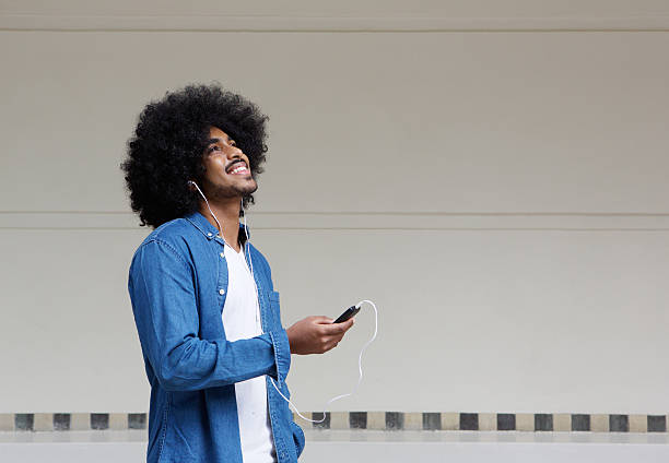 Cool guy listening to music on mobile phone