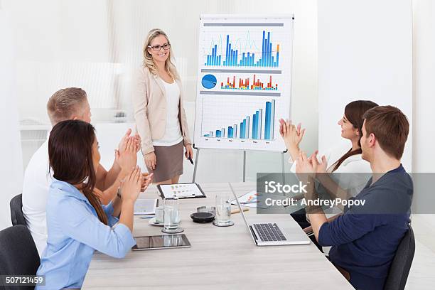 Businesspeople Clapping For Female Colleague After Presentation Stock Photo - Download Image Now