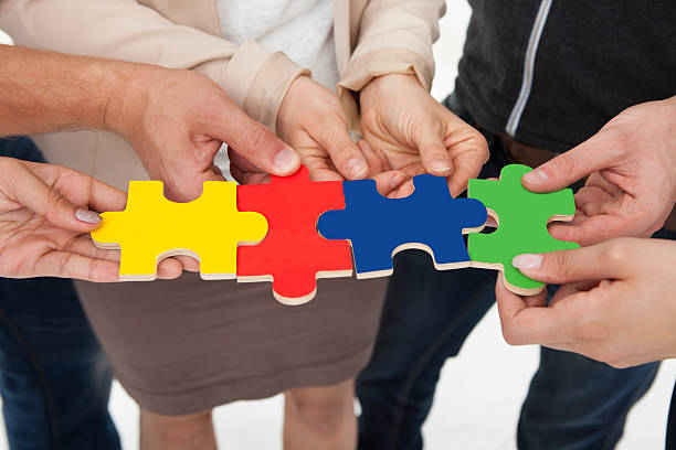 istock Businesspeople Joining Puzzle Pieces 507121871